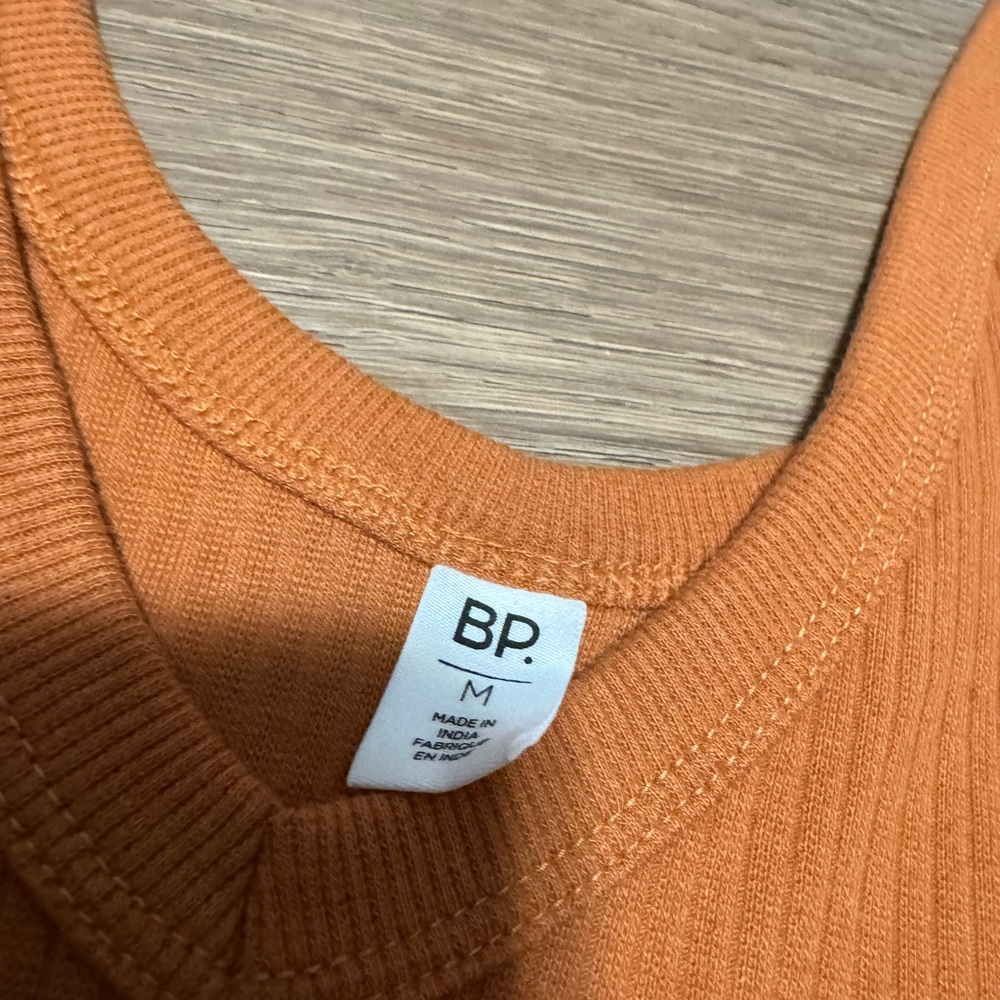 Woman’s orange/brownish one piece cloth bodysuit